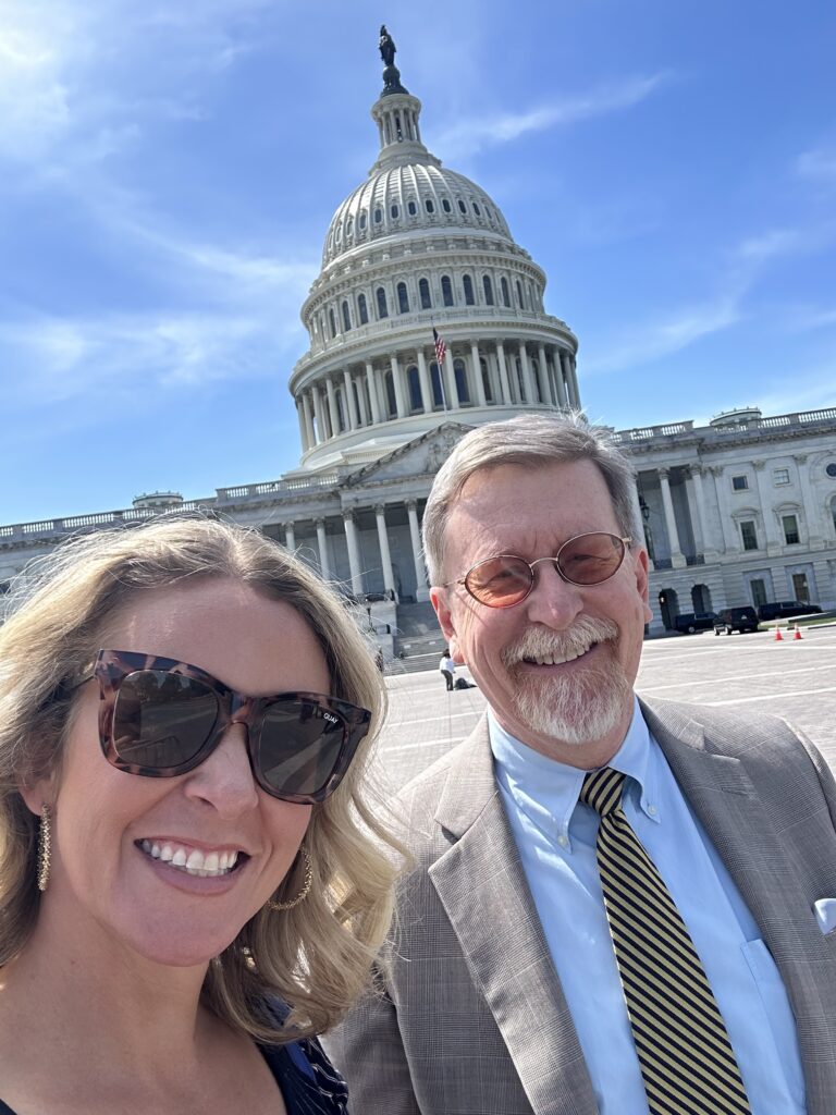Sarah Waters, chief advocacy officer, and John McKechnie, contract lobbyist, stand in front of the Capitol.
