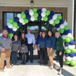 Scenic Community Credit Union employees gather for a group picture at the new East Brainered Branch. Scenic Community Credit Union