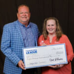 Fred Robinson, president and CEO of the League, presents a check to Karen Hunter-Lowery, senior director, Children's Miracle Network Hospitals at Monroe Carell Jr. Children's Hospital at Vanderbilt Miracle Network, with proceeds from the golf tournament. Event photography by Dan Henry Photography.