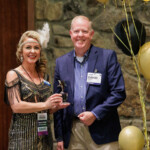 Sarah Waters, chief advocacy officers, presents the TriStar Advocate of the Year Award to David Smart, president and CEO of Trust Federal Credit Union.
