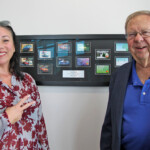 Prior board chair, Melecia Matias, and Criss Browning from the Tennessee Credit Union League admire a history of VFCU debit cards down through the years.
