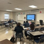 A representative from Leaders Credit Union speaks at a teacher in-service event.