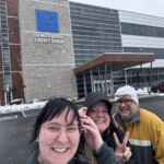 Employees at ORNL Federal Credit Union take a picture as the snow falls.