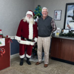 Kendall Foster, CEO of Scenic Community Credit Union, with Santa.