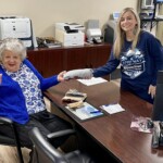 An Appalachian Community Federal Credit Union member accepts a credit union T-shirt.