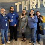ORNL Federal Credit Union employees showcase their International Credit Union Day pins. The credit union commemorated the day by making a donation to East Tennessee Children's Hospital and the World Council of Credit Unions.