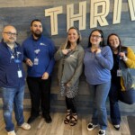ORNL Federal Credit Union employees showcase their International Credit Union Day pins. The credit union commemorated the day by making a donation to East Tennessee Children's Hospital and the World Council of Credit Unions.