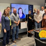 ORNL Federal Credit Union employees showcase their International Credit Union Day pins. The credit union commemorated the day by making a donation to East Tennessee Children's Hospital and the World Council of Credit Unions.