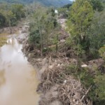 Logs and debris line the edge of the river. Photo taken by the son-in-law of Amy Banks, CEO of Clinchfield Federal Credit Union in Erwin.