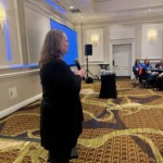 Karen Hunter-Lowery,
senior director, CMN Hospitals, speaks at the bag-assembly event.