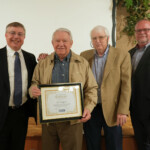 Mark Fraker, CEO of Chattanooga Federal Employees Credit Union, Jack Boran, board chair, and Fred Robinson, president and CEO of the Tennessee Credit Union League, honor Bill Swafford for 44 years of board service.