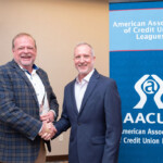 Fred Robinson, president and CEO of the Tennessee Credit Union League, shakes hands with Brad Miller, president of AACUL.