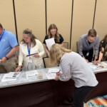 Credit union chapter leaders participate in an interactive reality fair simulation.