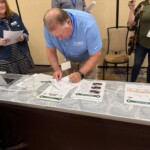 Credit union chapter leaders participate in an interactive reality fair simulation.