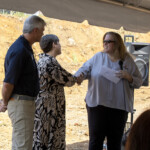 Allison Hedrick, marketing manager at Enrichment Federal Credit Union, presents Emily Wheaton and Dean Deathrige from the Debusk Family Boys and Girls Club with a donation in celebration of the groundbreaking.
