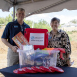 Dean Deathrige and Emily Wheaton from the Debusk Family Boys and Girls Club
receive a $1,000 Community Enrichment donation and a bin overflowing with supplies from Enrichment Federal Credit Union during the groundbreaking ceremony on Wednesday, July 30.