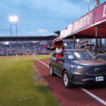 Louie rides around the field in a gently used car!