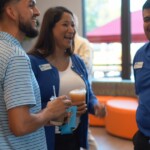 Grand opening attendees enjoy coffee from a local coffee shop.