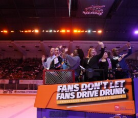 UT Federal Credit Union leaders ride the fanboni across the ice.