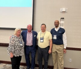 Sandy Lingerfelt, left, gathers for a group photo at a volunteer leaders event hosted by the League.