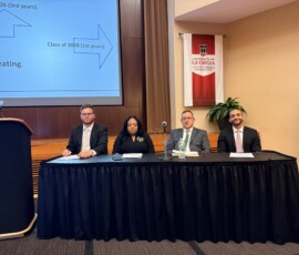 Jordan Barto with Tennessee Valley Federal Credit Union, first from left, prepares for the debate on the focus of credit unions—people or profits.