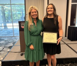 Jessica Boring with Copper Basin Federal Credit Union stands beside Kim Bohannon with the Association after the graduation ceremony.
