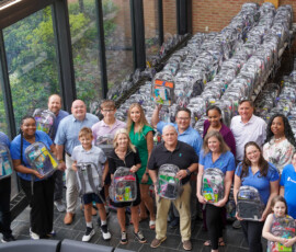Southern Security Credit Union employees stand with 650 backpacks filled with school supplies for the Youth Villages Backpack Heroes Campaign.