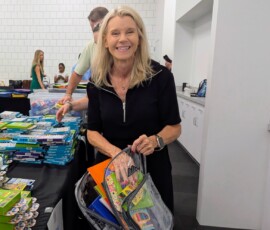 Dawn Graeter, CEO of Southern Security Credit Union, packs a backpack for the Youth Villages Backpack Heroes Campaign.