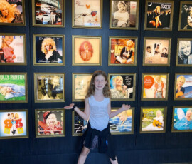 A credit union employee's child stands in front of Dolly's records at the DreamMore Resort.