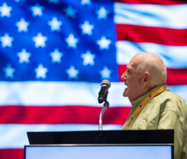 Dickie Johnson, board member with Enbright Credit Union, leads the Pledge of Allegiance.