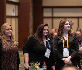 Young professionals stand to be recognized during the Awards Ceremony.