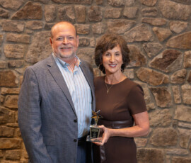Fred Robinson, president and CEO of AnchorPoint, congratulates Laura Parham, president and CEO of Heritage South Community Credit Union, for being named TriStar Advocate of the Year.
