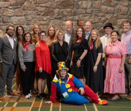 AnchorPoint team members gather for a group photo celebrating the "Under the Big Top: Where Innovation Takes Center Stage" exhibit hall theme.