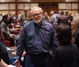 Charles Elliott, AnchorPoint ex officio president, talks with young professionals.