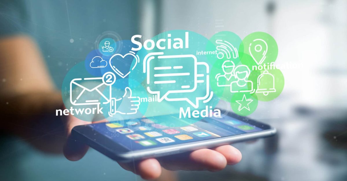 Businessman holding a cloud of social media network icon